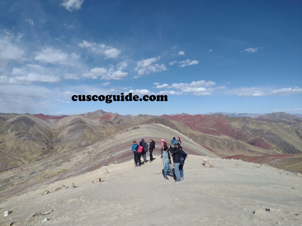 Palcoyo Pass in the Andes, featuring colorful mountains and rolling hills beneath a clear sky in Peru.